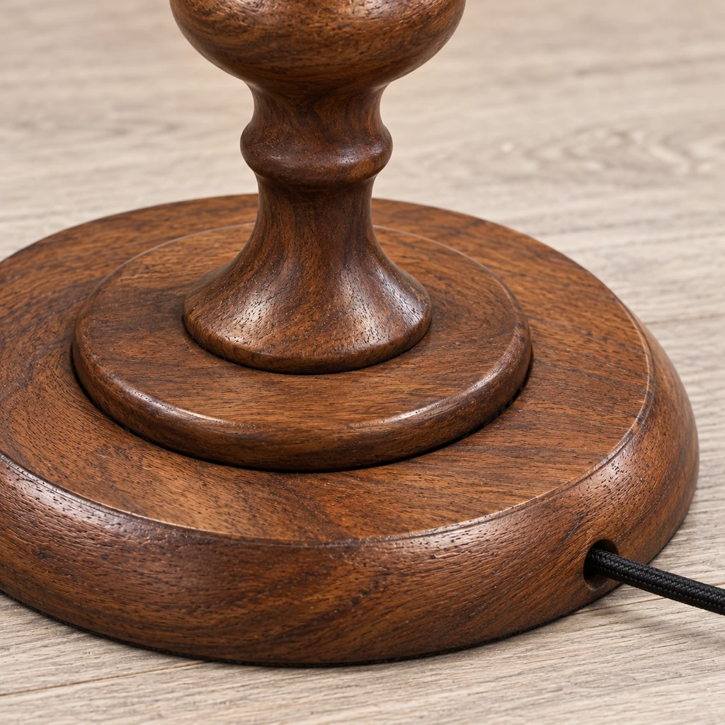 Close detail of the circular wood base and trailing cord exit
