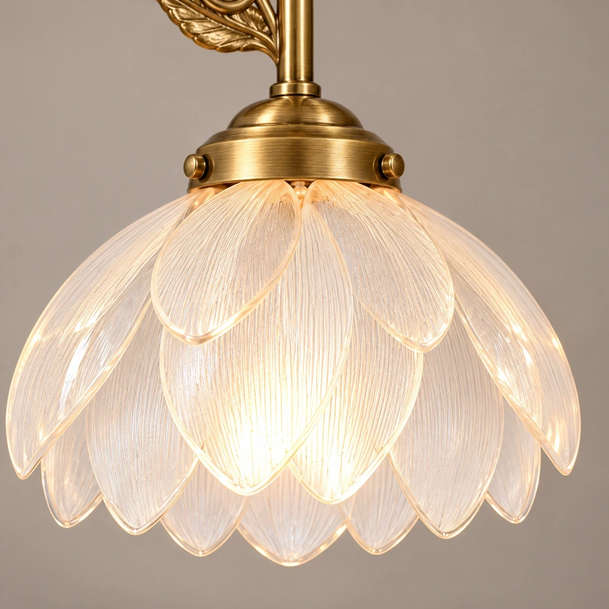 Close view of the translucent petal-form acrylic shade and copper-toned socket