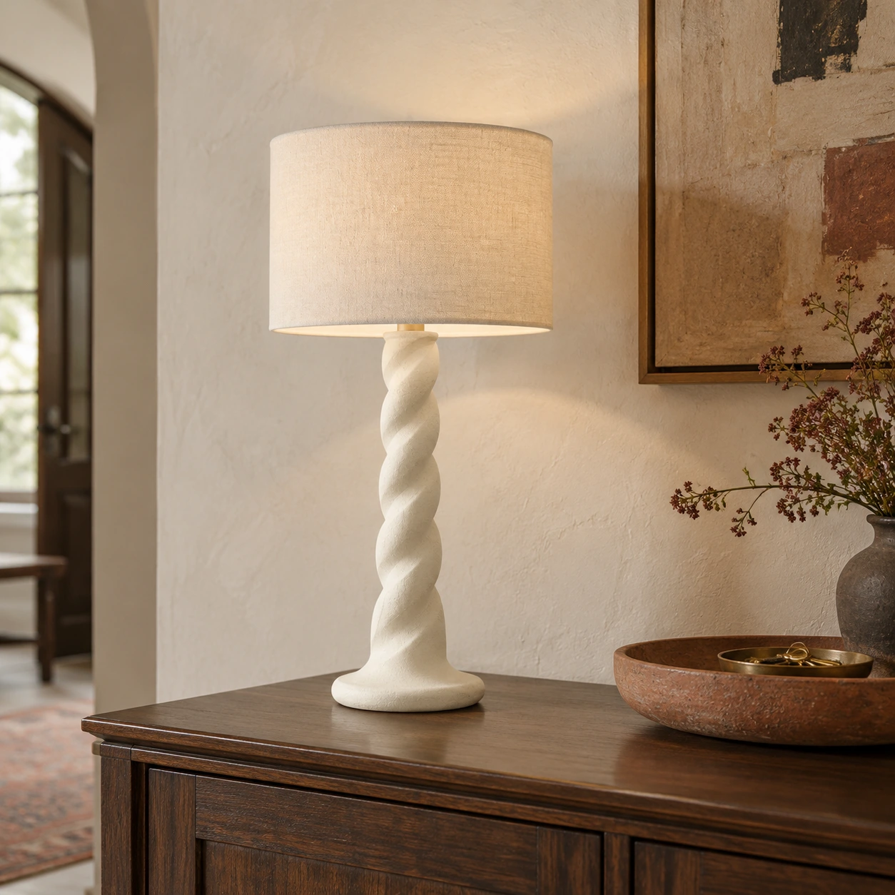 Twisted carved wood table lamp on an entryway sideboard