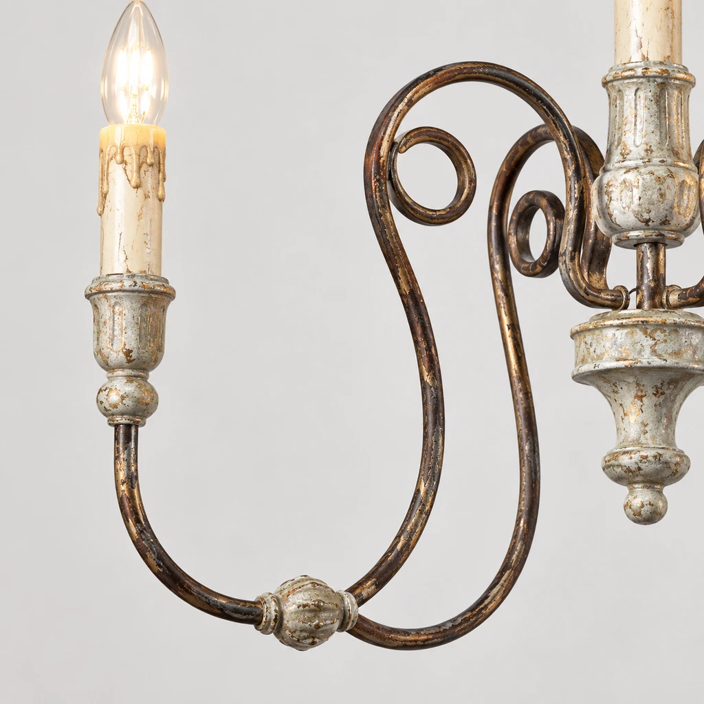 Close detail of a scrolling arm and candle-style socket