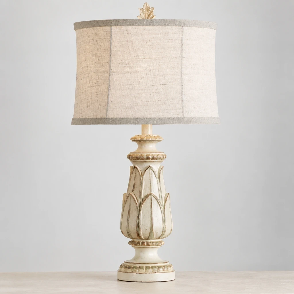Rustic Carved Floral Table Lamp switched off in a neutral studio