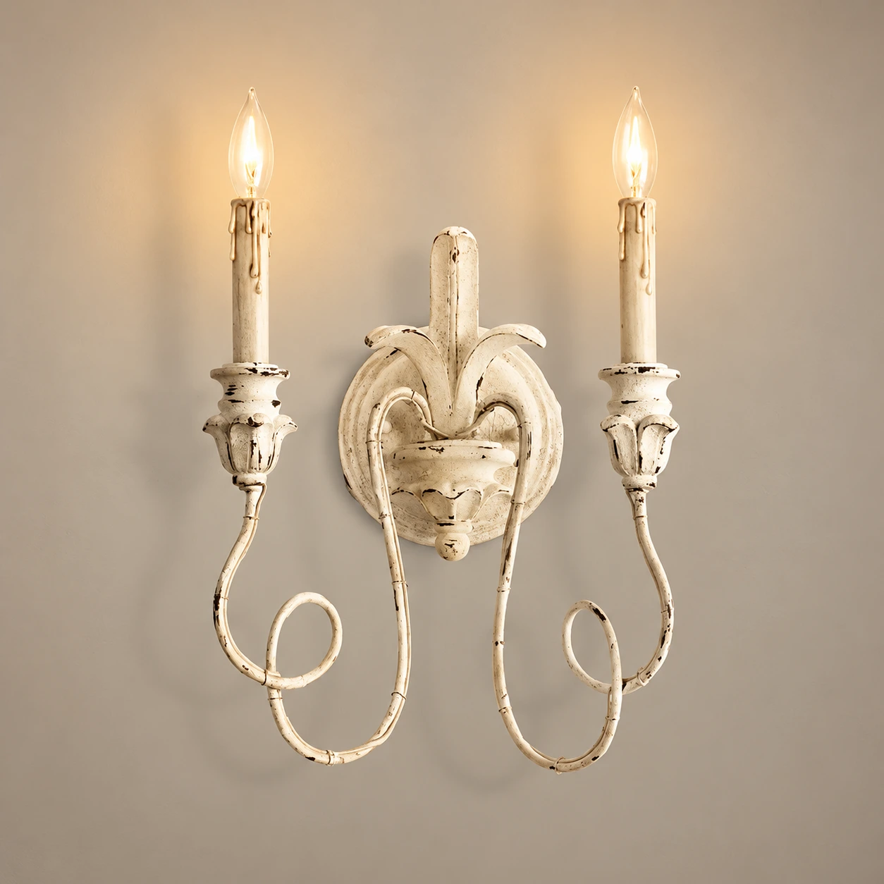 Cassia white aged wall sconce illuminated in a neutral studio