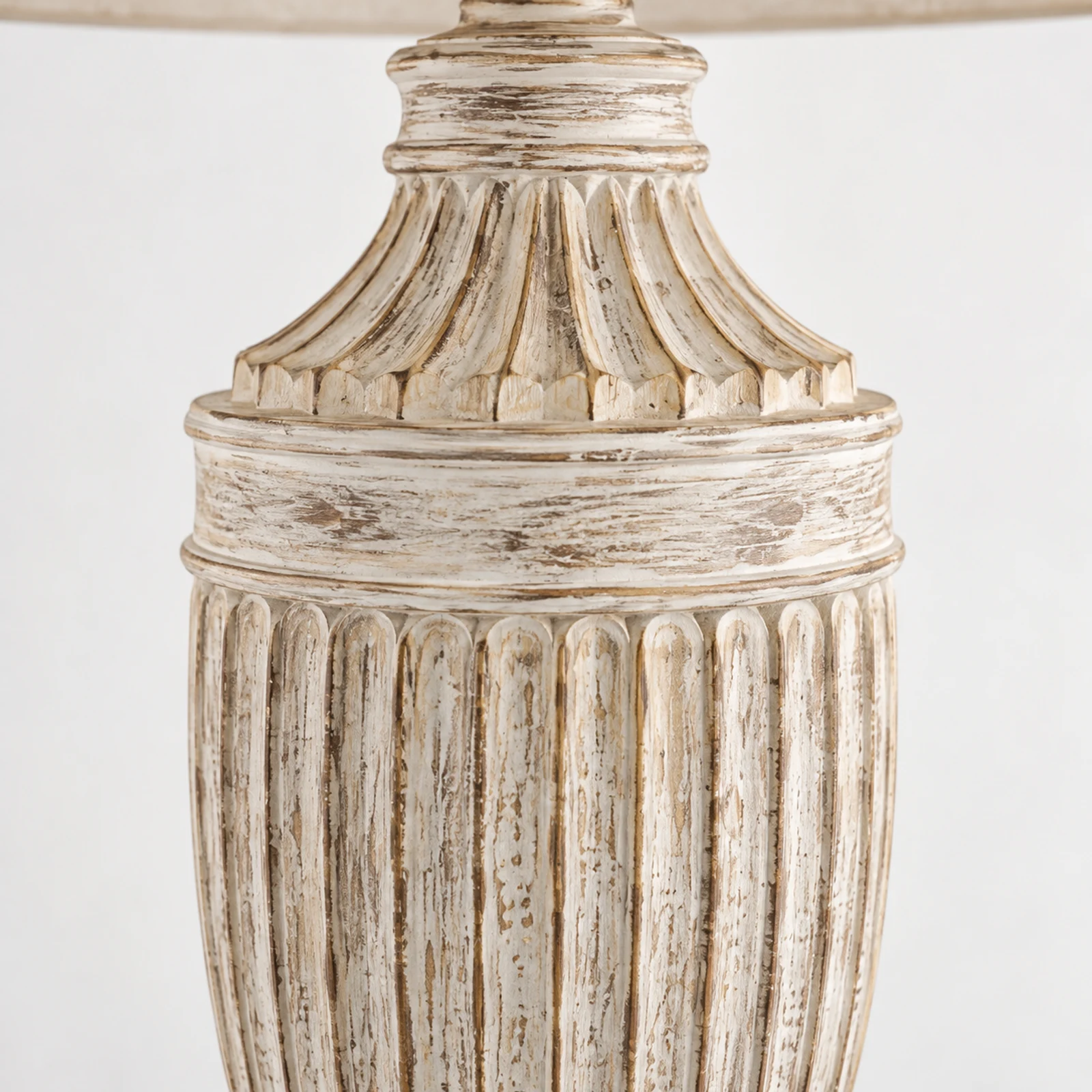Close detail of the vertically fluted carved solid-wood urn body