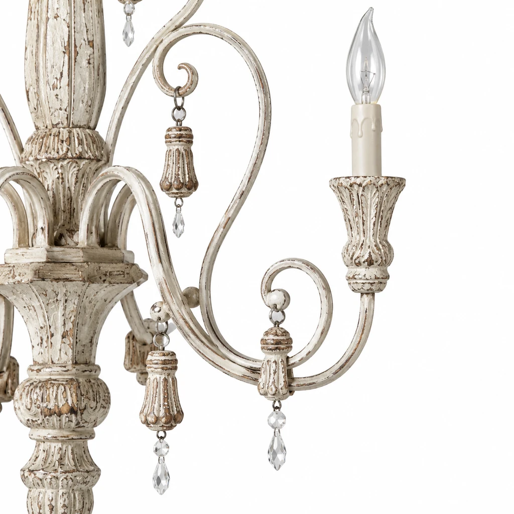 Close detail of a curled arm, candle socket and hanging ornament