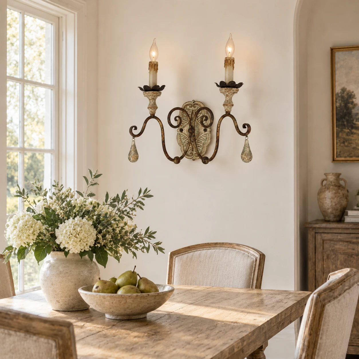 Two-light wood and iron wall sconce beside a dining table