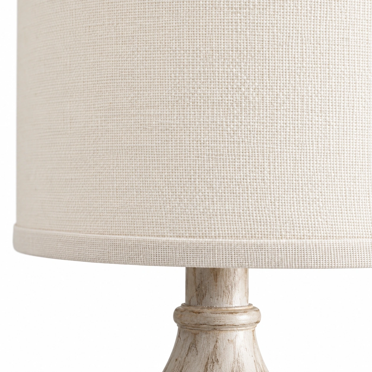 Close view of the off-white fabric shade hem