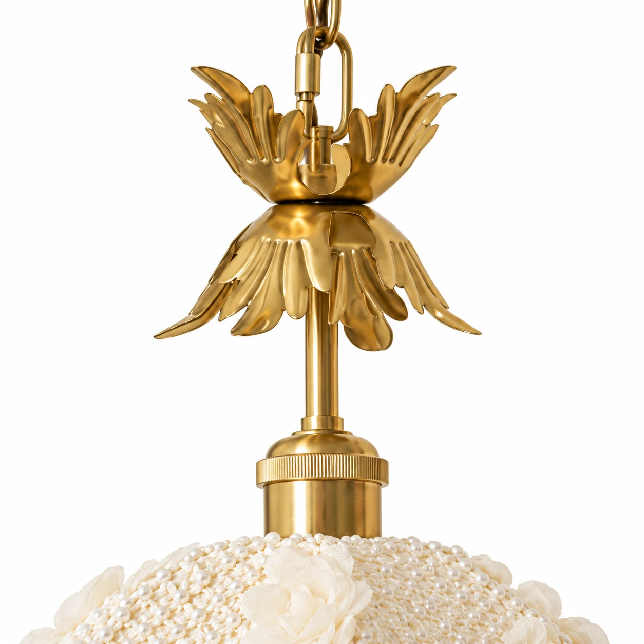 Brass leaf hardware at the top of the fabric shade