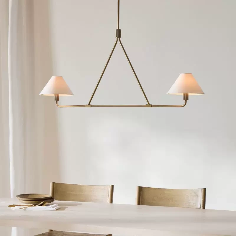 2-Light Gold linear chandelier over a small dining table