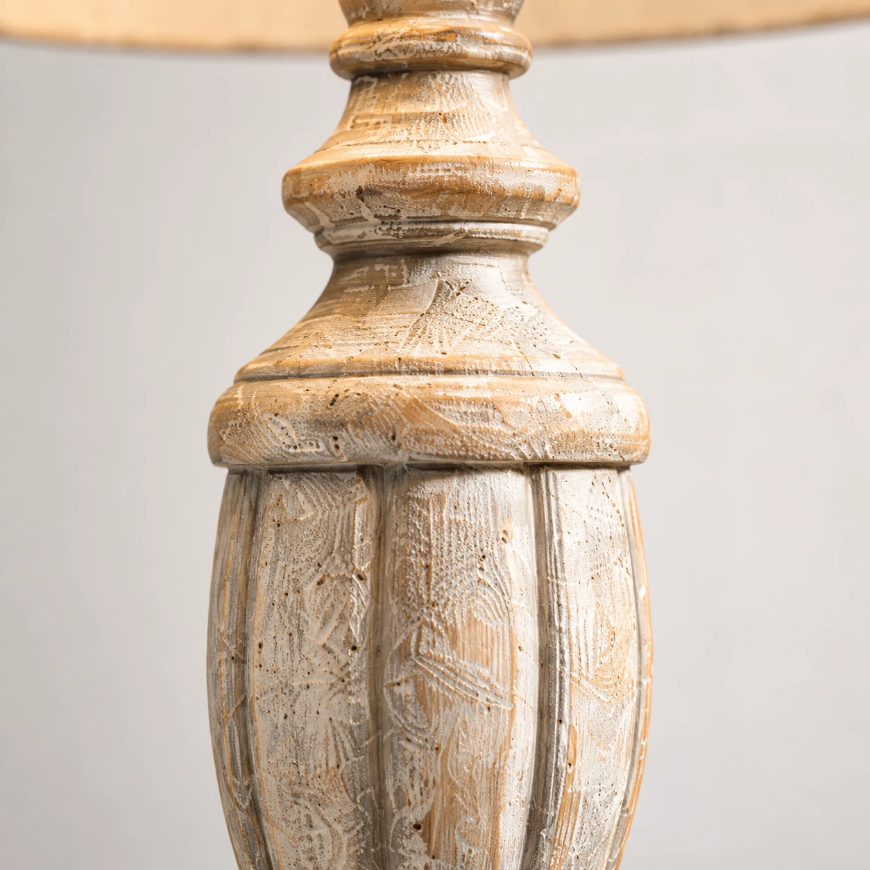 Close detail of the vertically fluted distressed solid-wood column