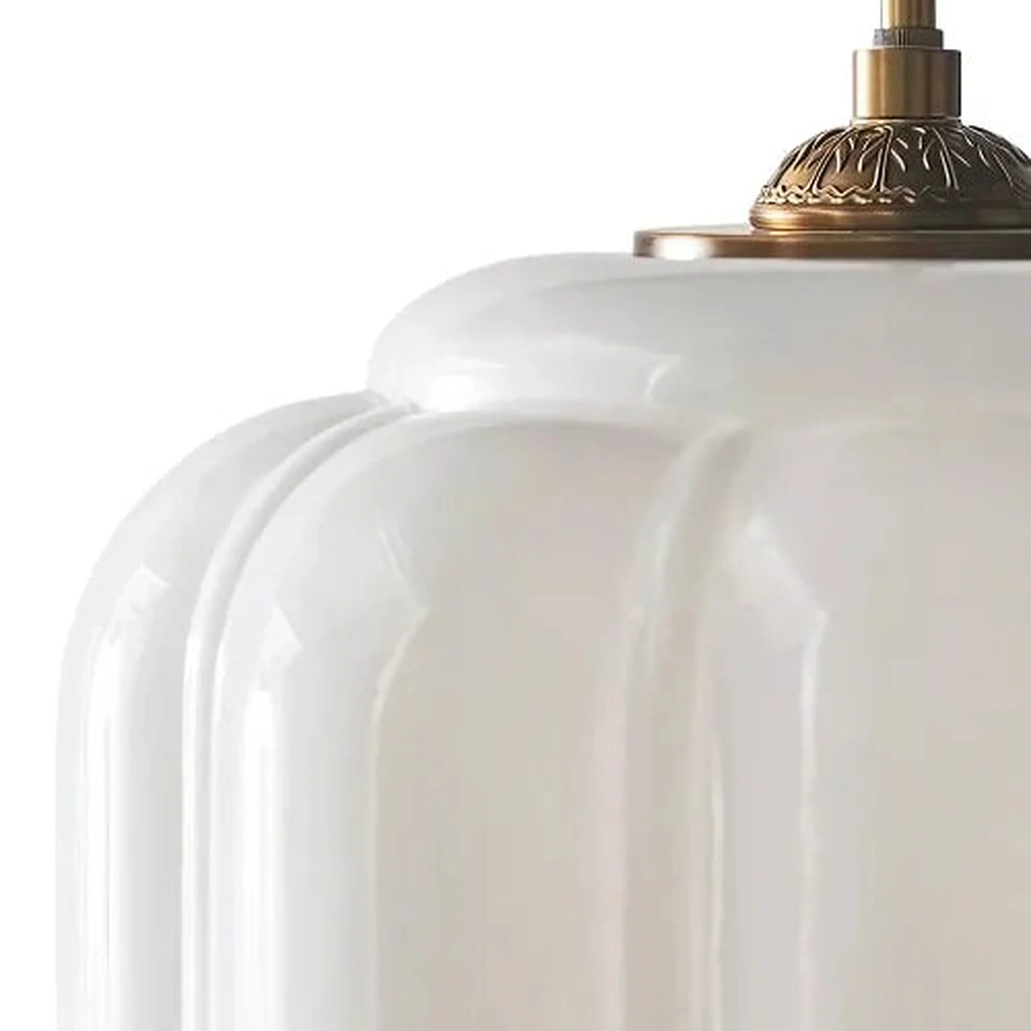 Close-up of ribbed white glass and the brass collar
