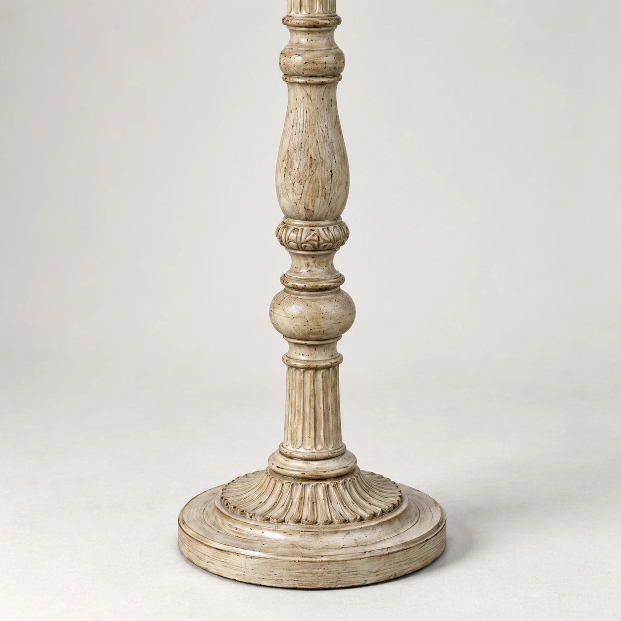 Détail de la base ronde et stable en bois sculpté