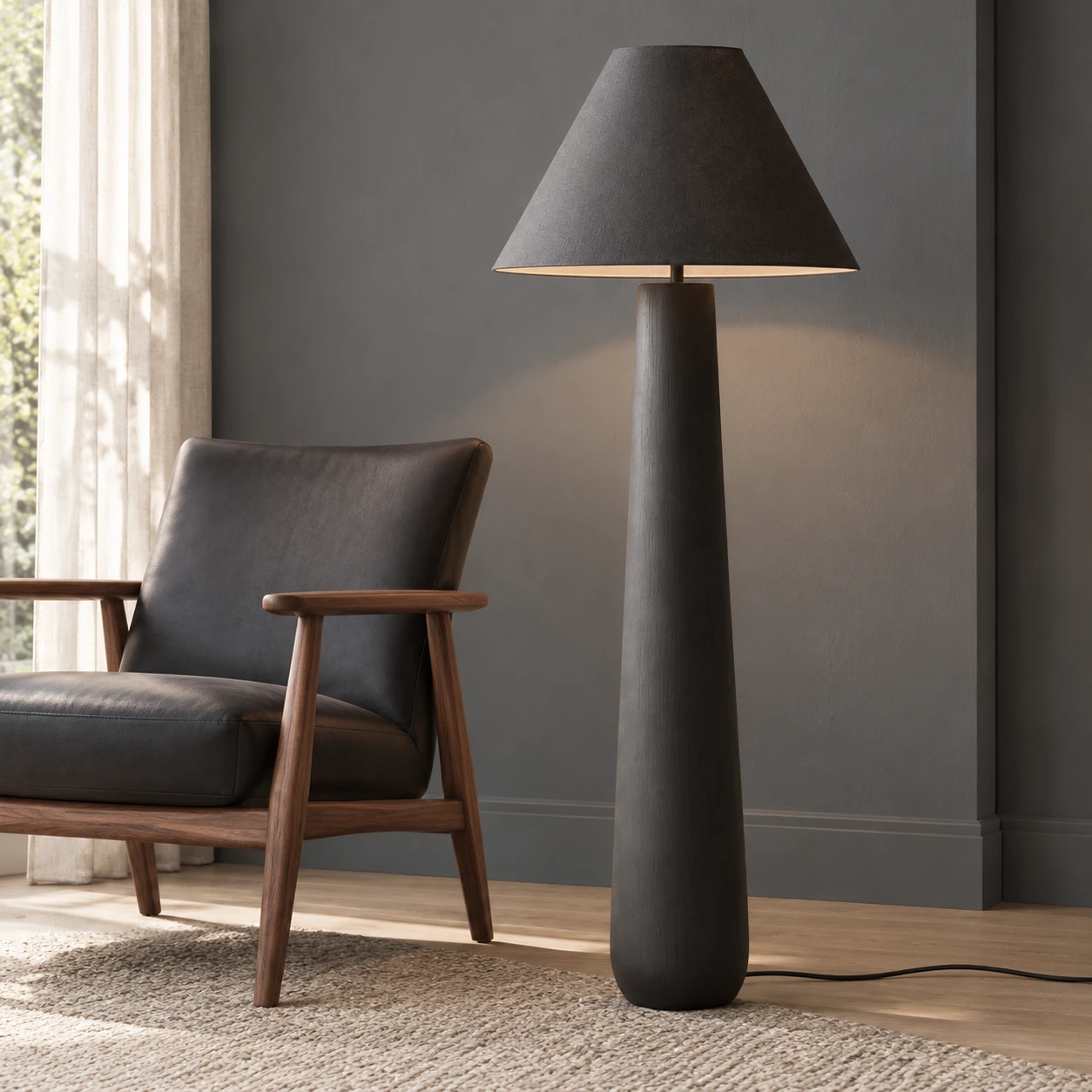 Lampadaire noir à côté d'un fauteuil lounge en noyer et anthracite