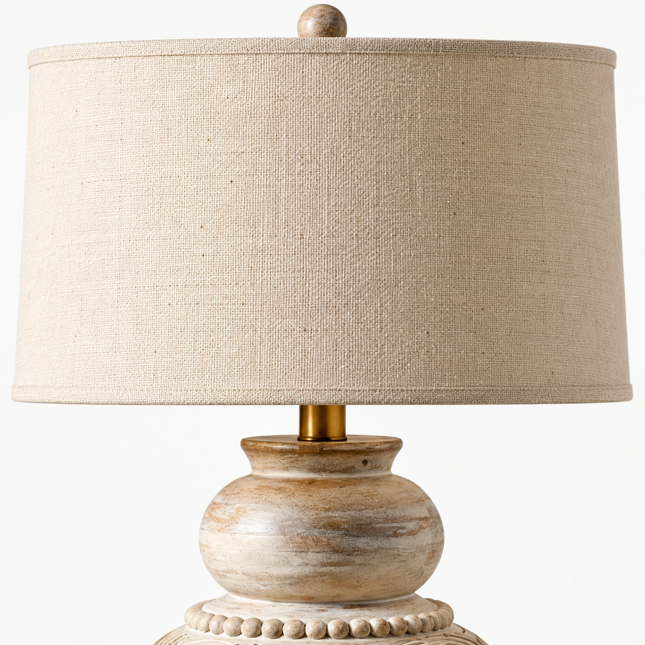 Close view of the linen shade, finial, and brass neck